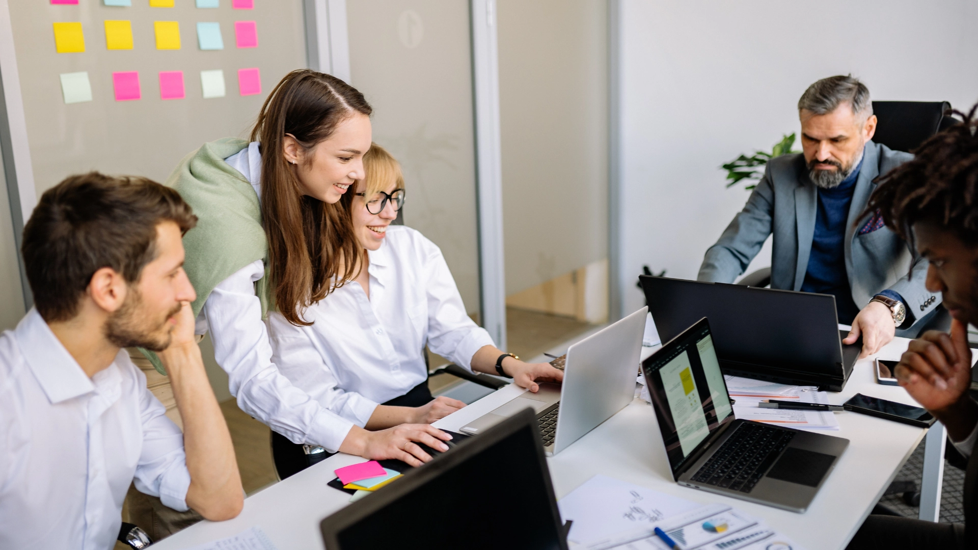 Work team collaborate in front of laptops in modern office